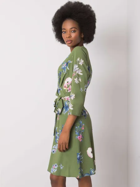 Women's green dress with plant patterns.