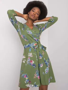 Women's green dress with plant patterns.